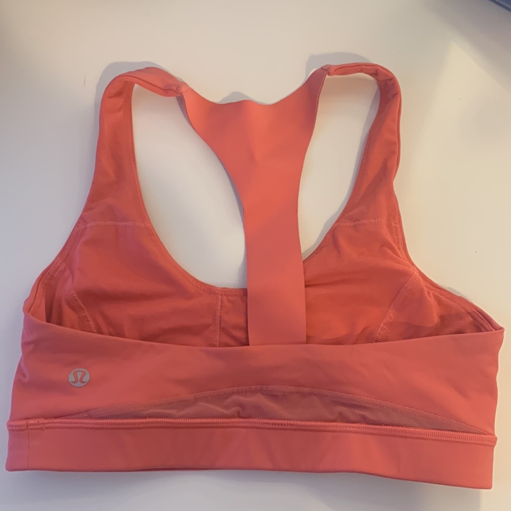 A coral lululemon sports bra in good condition barely worn fun pretty color